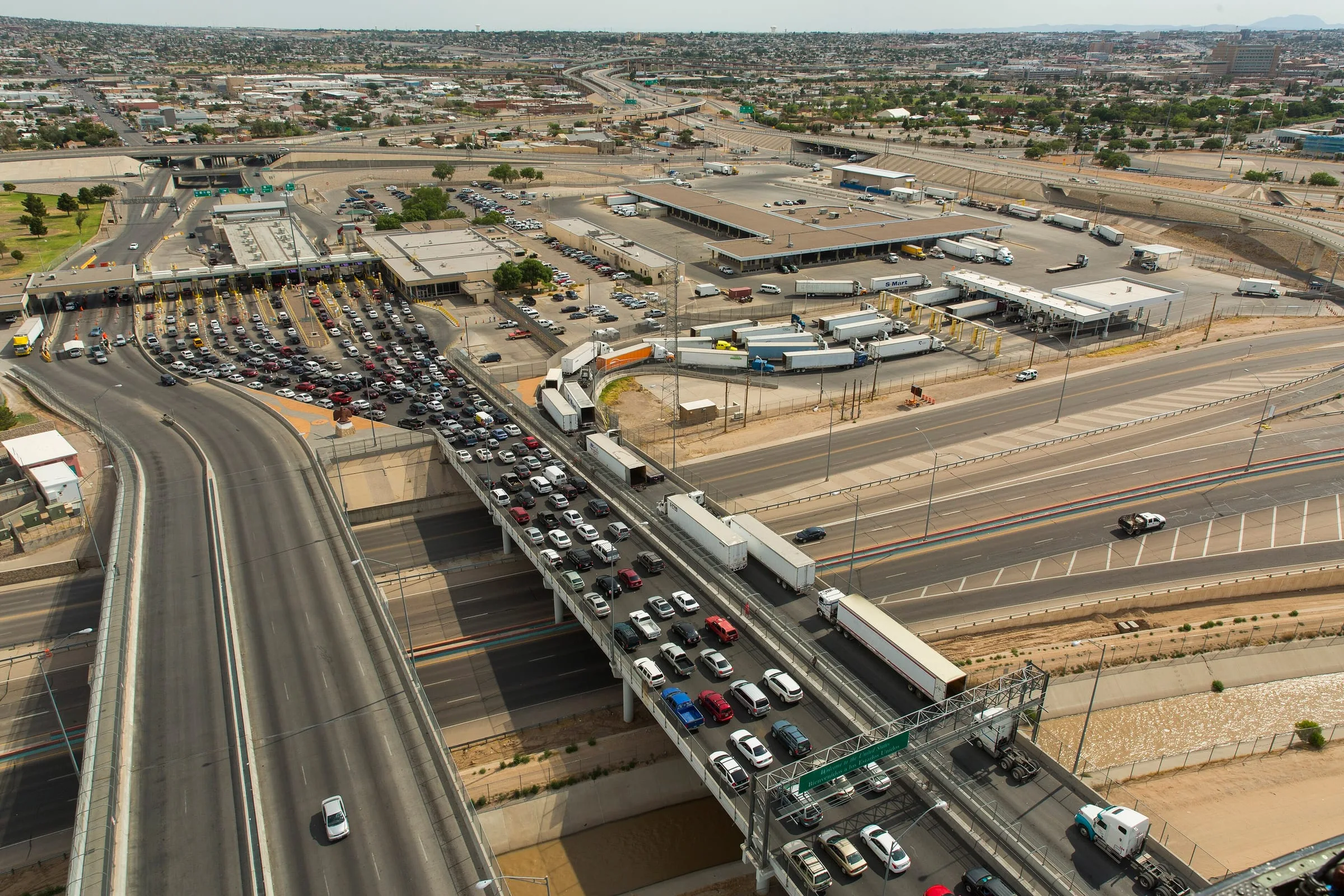 Aerial view of cars and freight trucks queued to cross at the Bridge of the Americas port of entry in El Paso
