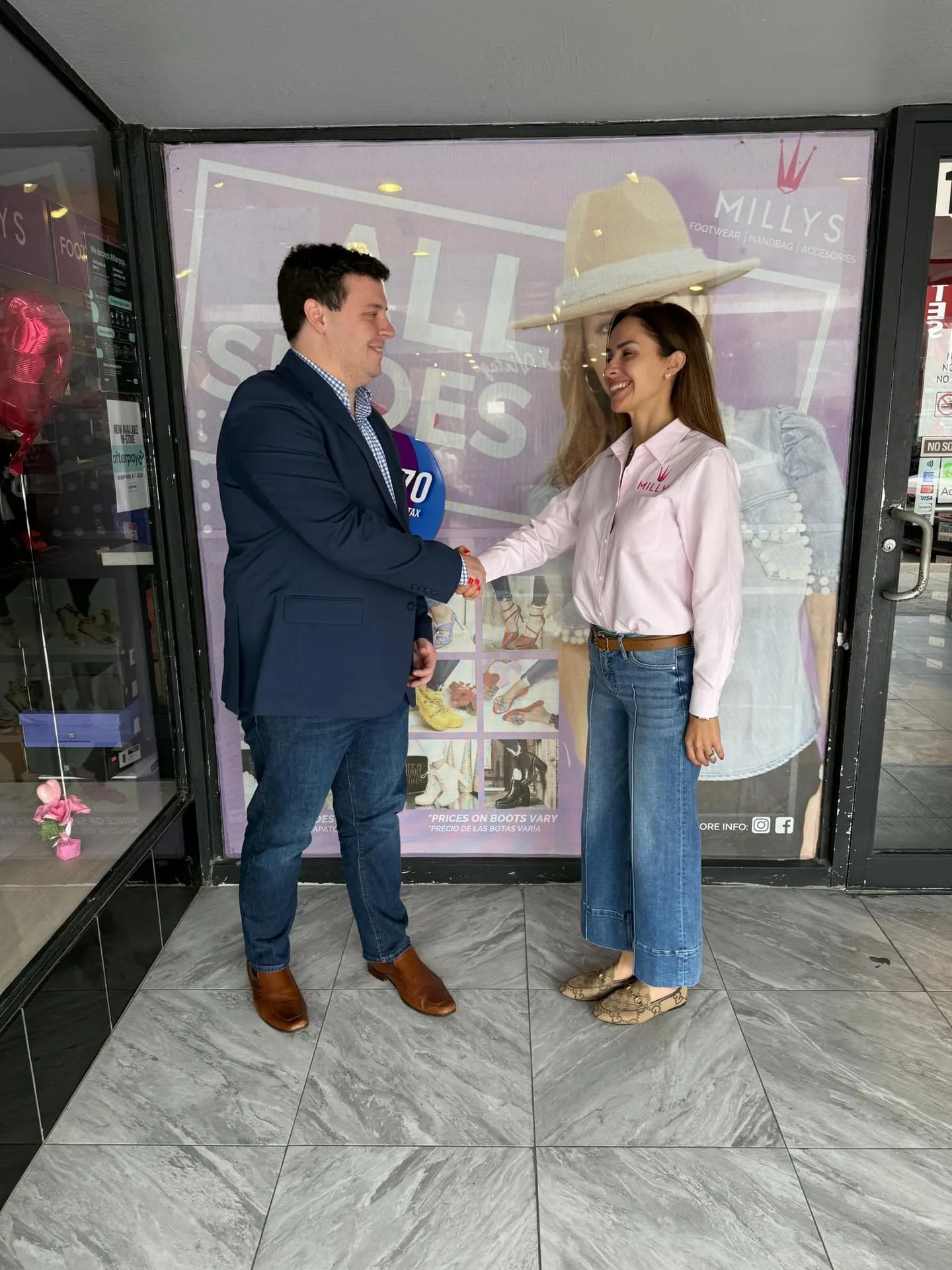 A CMA advisor shaking hands with a client outside her Texas storefront