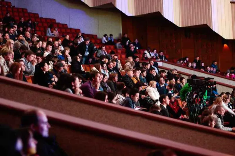 people sitting watching in the theater