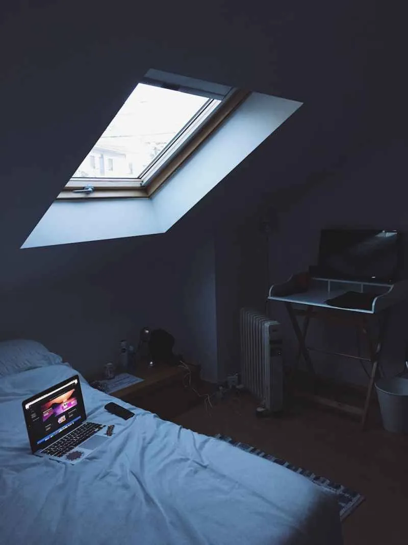 black laptop on bed