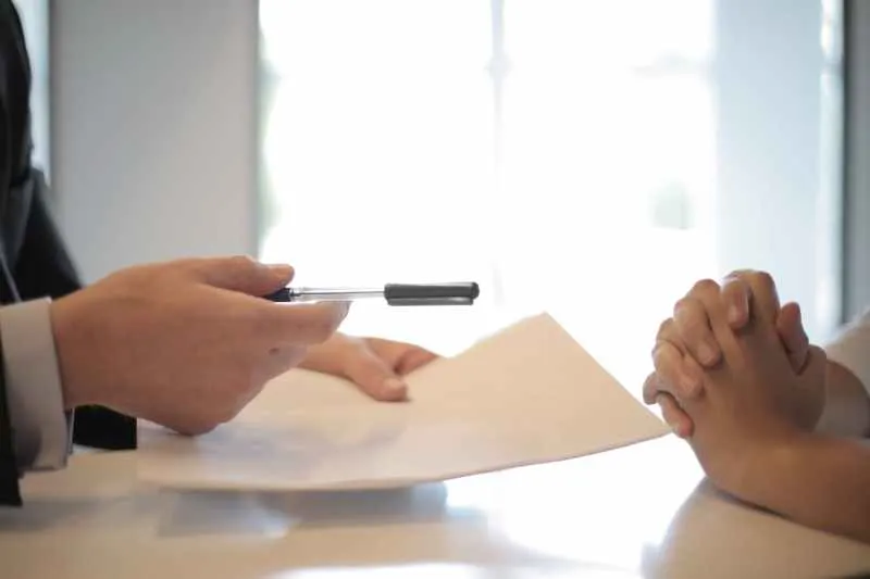 crop businessman giving contract to woman to sign