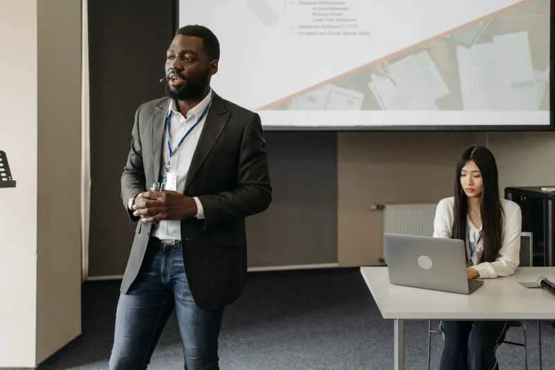 a man in gray suit jacket making a presentation