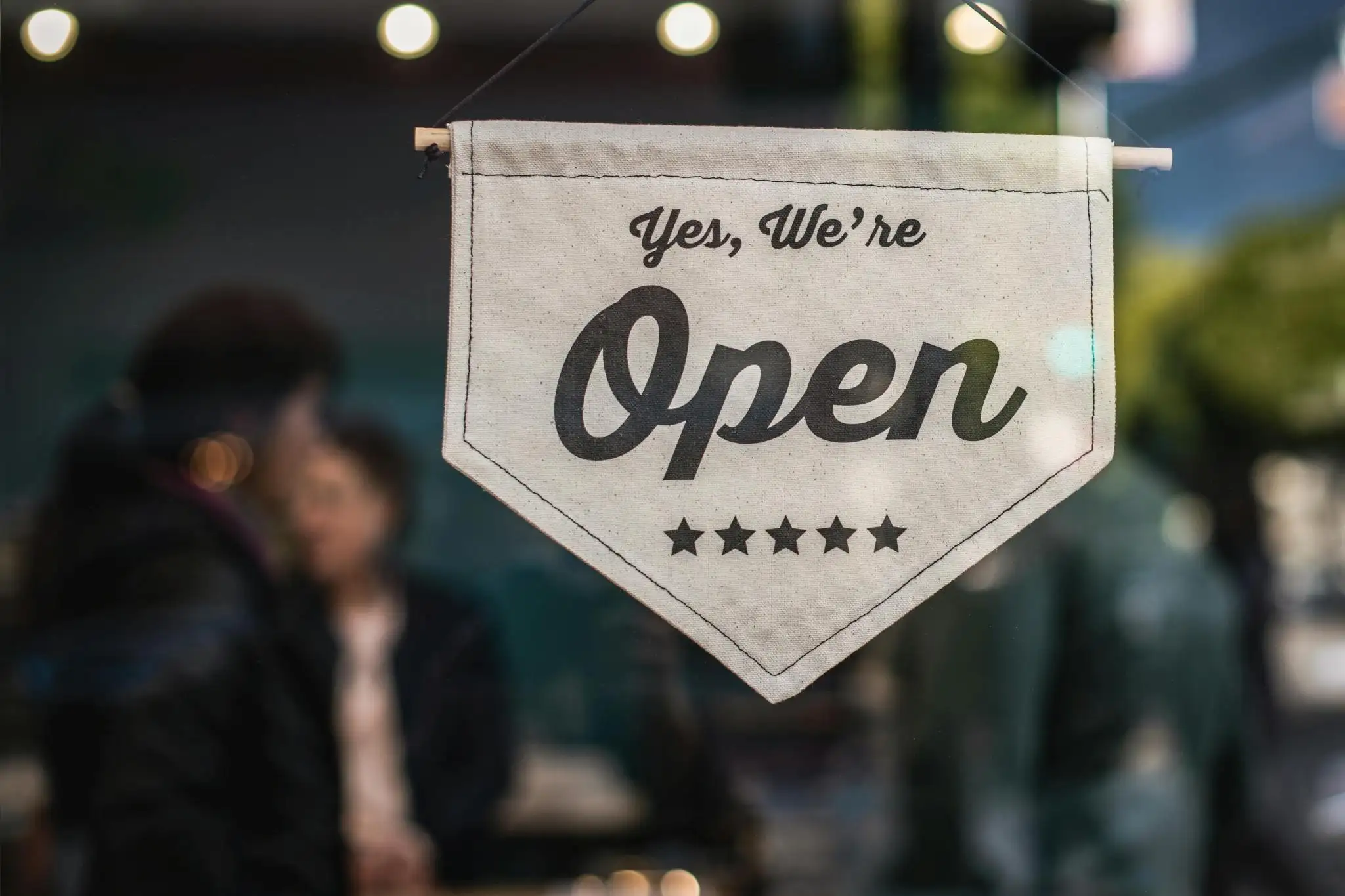 An open sign in a small shop window